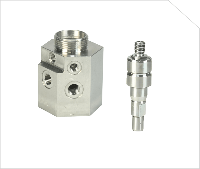 Two machined stainless steel value-added components.